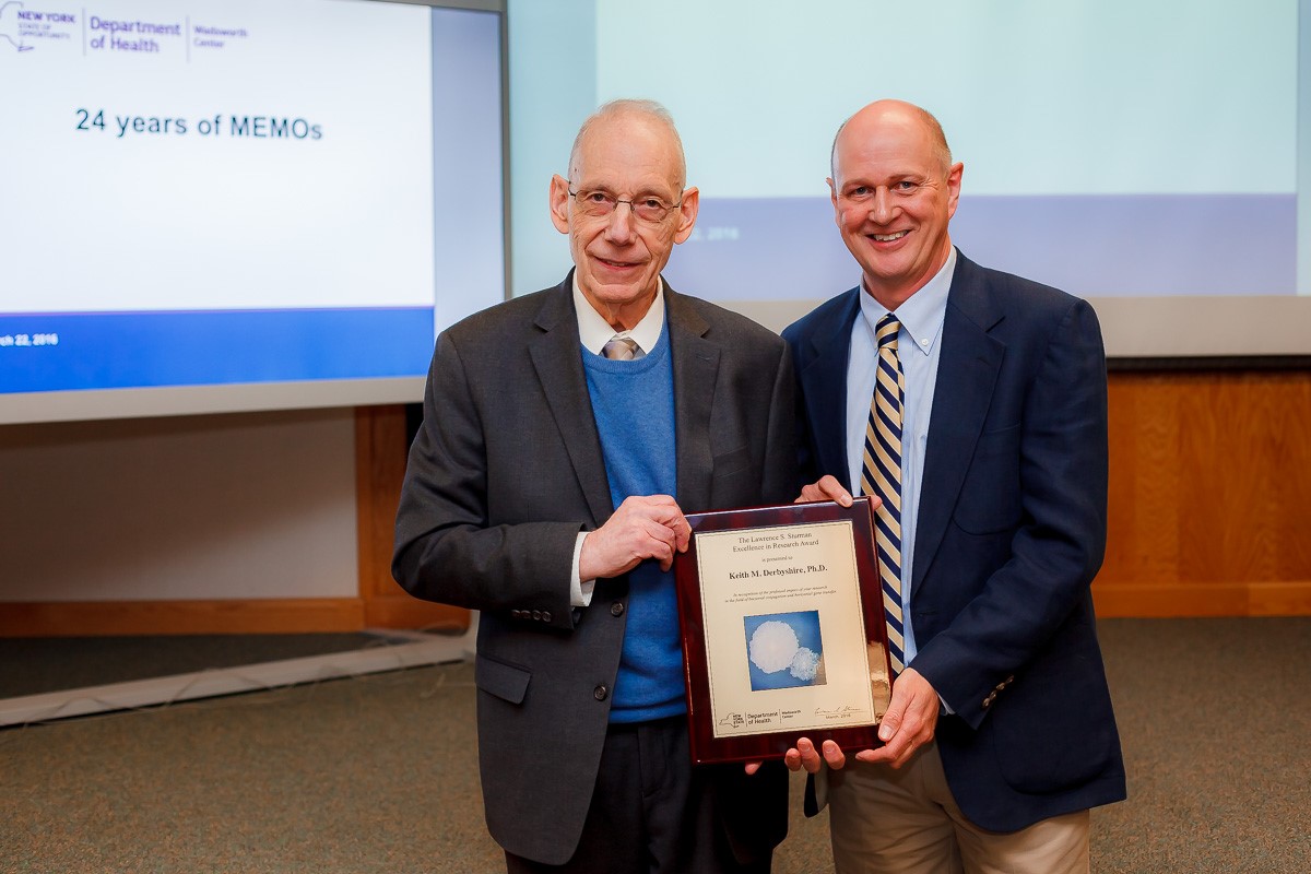 Dr. Lawrence Sturman, left, presents the 2016 research award named in his honor to Dr. Keith Derbyshire.