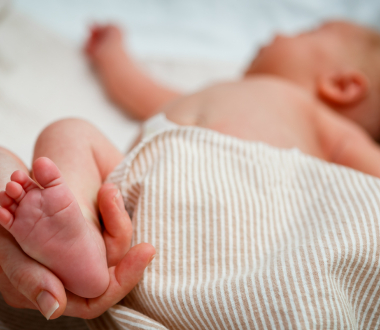 Newborn Screening Program hand holding infant heel Newborn Screening Program hand holding infant heel